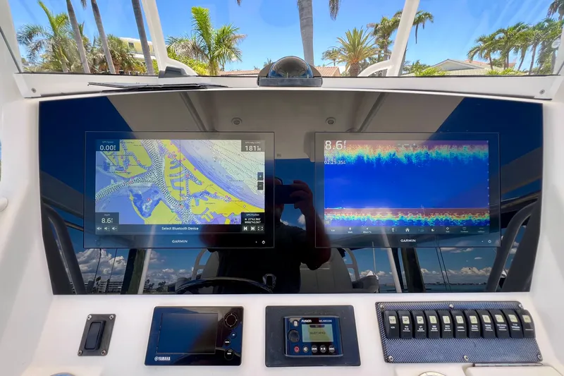 Redemption Yacht Photos Pics 2012 Regulator 34SS boat dashboard with Garmin navigation displays and control panel.