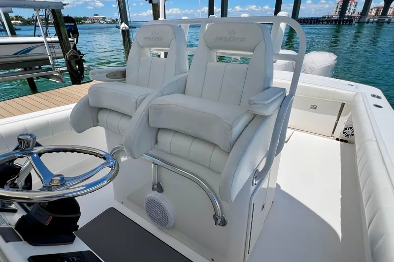Redemption Yacht Photos Pics 2012 Regulator 34SS boat interior with dual white captain's chairs and steering wheel.