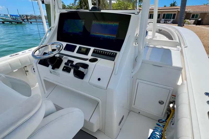 Redemption Yacht Photos Pics 2012 Regulator 34SS boat cockpit with steering wheel and navigation screens.