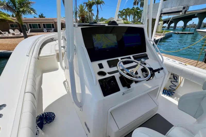 Redemption Yacht Photos Pics 2012 Regulator 34SS boat helm with modern controls and waterfront view.