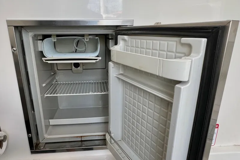 Redemption Yacht Photos Pics Open refrigerator on a 2012 Regulator 34SS boat, showing interior shelves and door.