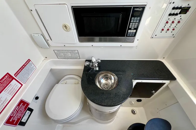 Redemption Yacht Photos Pics 2012 Regulator 34SS boat interior with sink, microwave, and toilet.