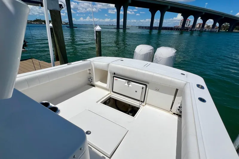 Redemption Yacht Photos Pics 2012 Regulator 34SS boat docked near a bridge on a sunny day.