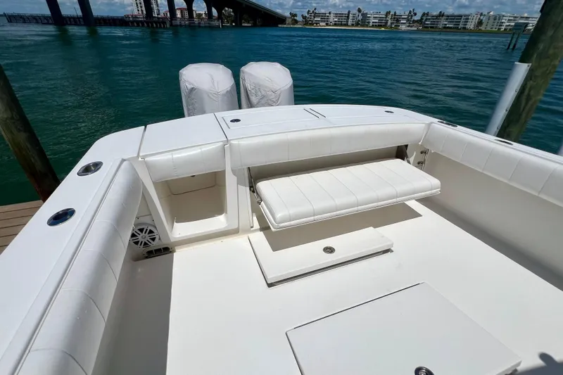 Redemption Yacht Photos Pics 2012 Regulator 34SS boat with white seating, docked near a bridge and waterfront buildings.