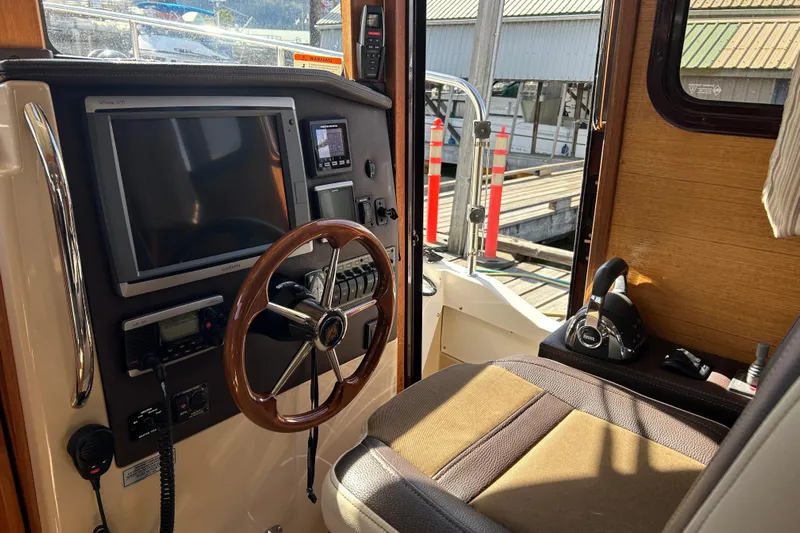  Yacht Photos Pics Interior helm of 2015 Ranger Tugs R-31 CB with steering wheel and navigation equipment.