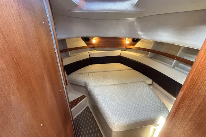  Yacht Photos Pics 2015 Ranger Tugs R-31 CB cabin interior with cozy bed and wooden accents.