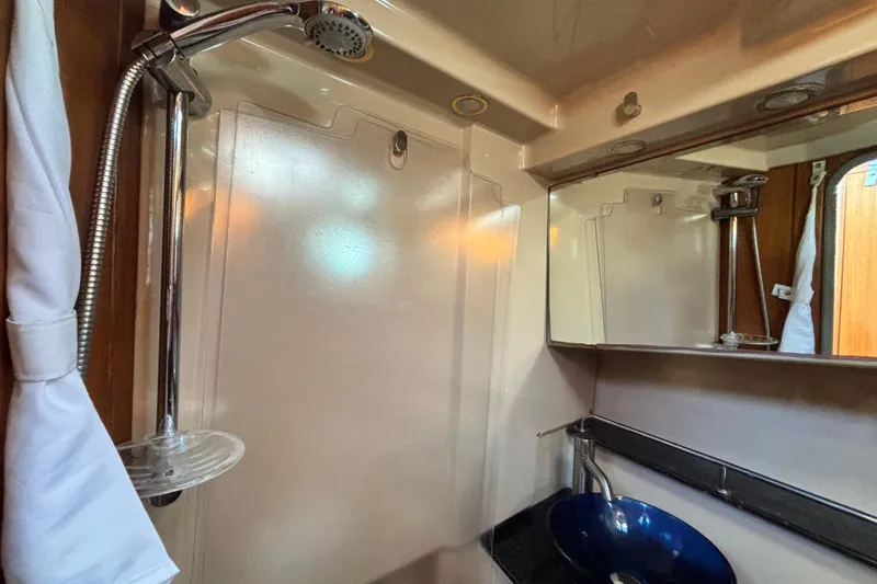  Yacht Photos Pics 2015 Ranger Tugs R-31 CB bathroom with shower, mirror, and blue sink.