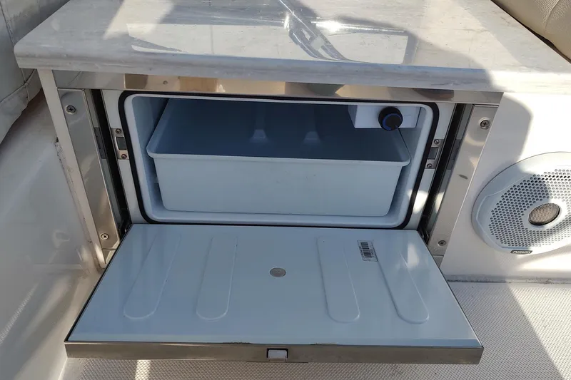 Me Yacht Photos Pics Built-in cooler on 2021 Regal 42 Fly yacht, open with storage compartment.