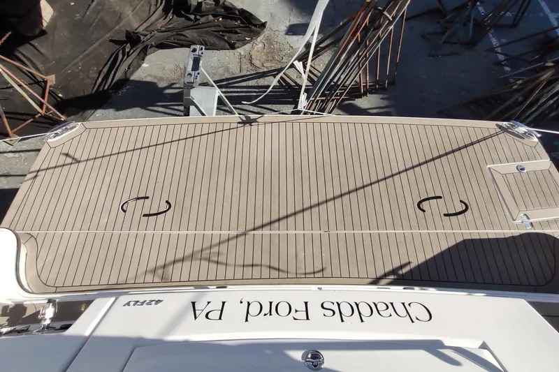 Me Yacht Photos Pics 2021 Regal 42 Fly yacht deck with wood finish, docked at a marina.