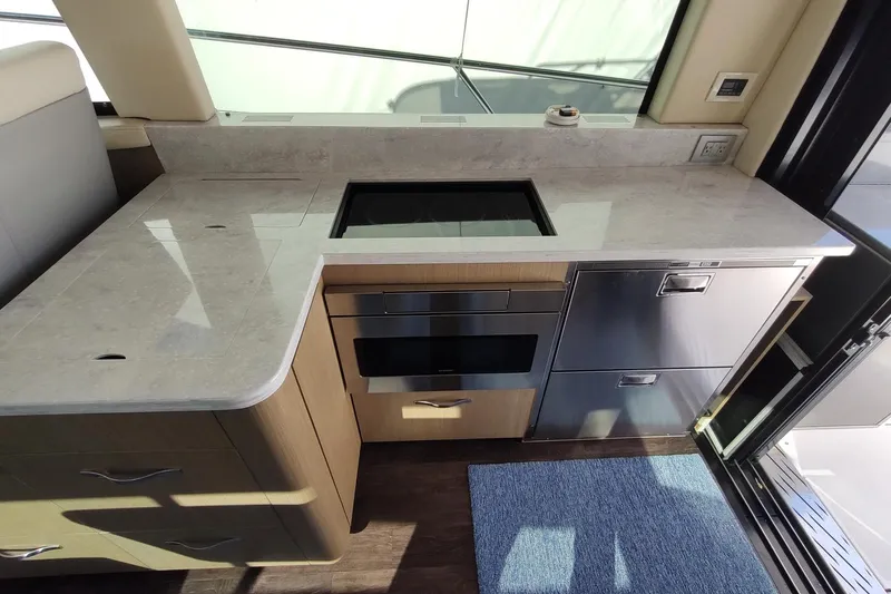 Me Yacht Photos Pics Modern kitchen area in 2021 Regal 42 Fly yacht with sleek countertops and appliances.