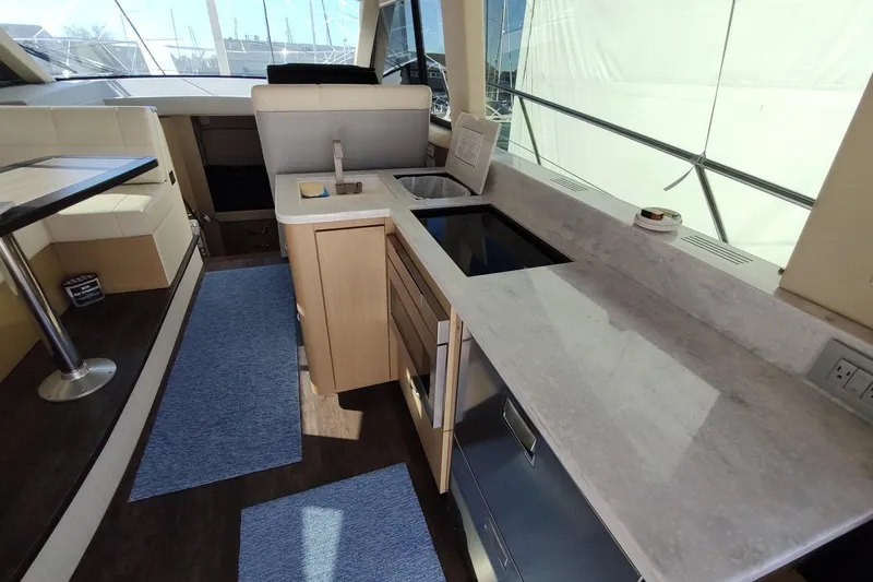 Me Yacht Photos Pics Luxurious interior of 2021 Regal 42 Fly yacht with modern kitchen amenities.