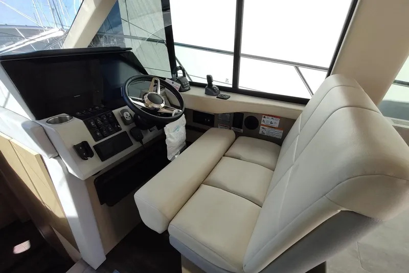 Me Yacht Photos Pics Helm station of 2021 Regal 42 Fly yacht with modern controls and comfortable seating.