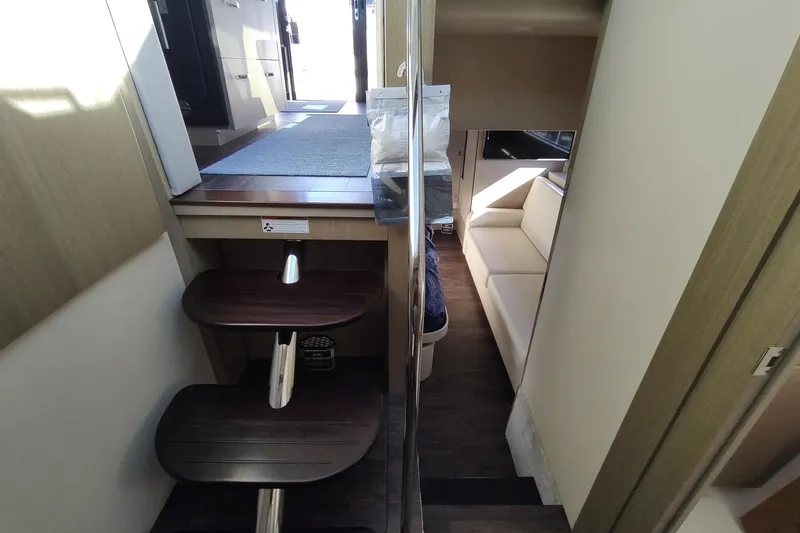 Me Yacht Photos Pics Interior view of 2021 Regal 42 Fly yacht, featuring stairs and a cozy seating area.