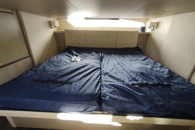 Me Yacht Photos Pics Luxurious bedroom interior of 2021 Regal 42 Fly yacht with blue bedding.