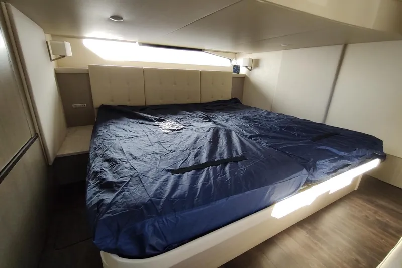 Me Yacht Photos Pics Luxurious bedroom interior of 2021 Regal 42 Fly yacht with blue bedding.