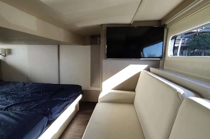 Me Yacht Photos Pics Luxurious interior of 2021 Regal 42 Fly yacht with bed, sofa, and TV.