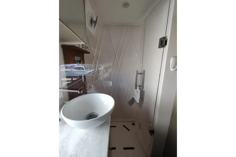 Me Yacht Photos Pics Modern bathroom interior of 2021 Regal 42 Fly yacht, featuring sleek sink and shower.
