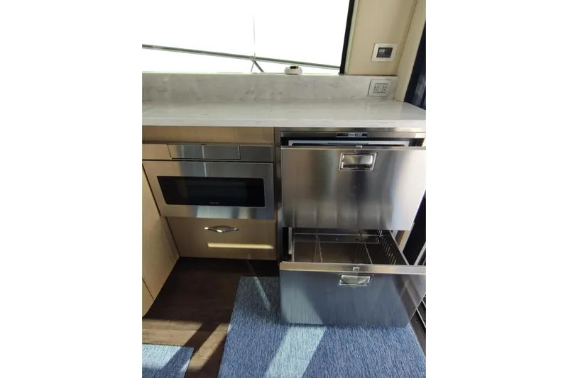 Me Yacht Photos Pics Modern kitchen area in 2021 Regal 42 Fly yacht with stainless steel appliances.