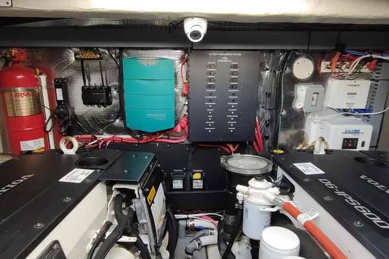 Me Yacht Photos Pics Engine room of 2021 Regal 42 Fly yacht with battery management system and fire extinguisher.
