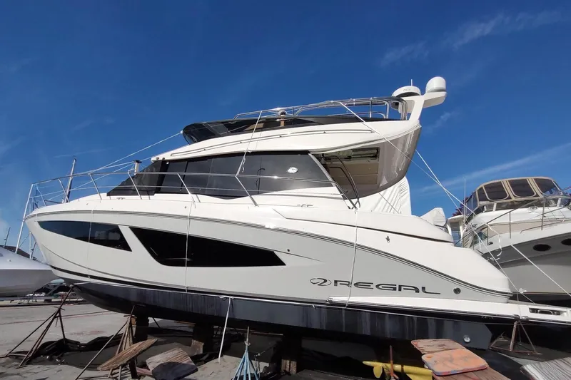 Me Yacht Photos Pics 2021 Regal 42 Fly yacht on dry dock under clear blue sky.