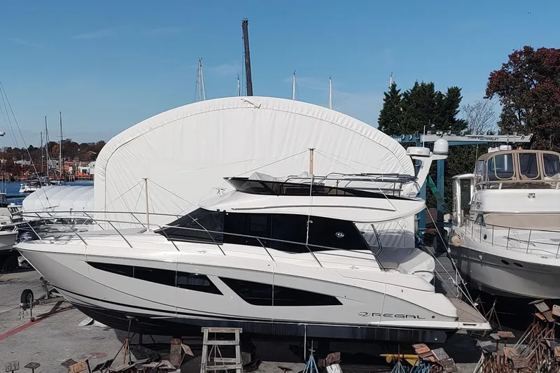 Me Yacht Photos Pics 2021 Regal 42 Fly yacht docked at a marina, surrounded by other boats.