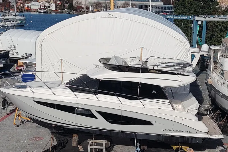 Me Yacht Photos Pics 2021 Regal 42 Fly yacht docked at a marina, side view.