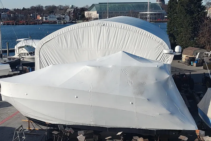 Me Yacht Photos Pics 2021 Regal 42 Fly yacht covered in protective wrap at a marina.