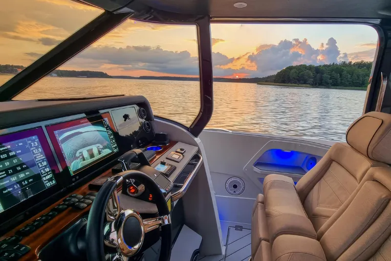  Yacht Photos Pics Luxurious 2024 Wiszniewski Yachts W43 helm with sunset view over serene waters.
