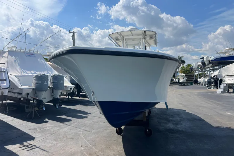  Yacht Photos Pics 2019 Yellowfin 29 Offshore boat in marina, clear sky background.