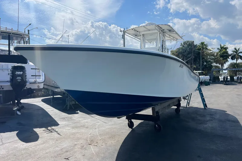  Yacht Photos Pics 2019 Yellowfin 29 Offshore boat on trailer under blue sky.