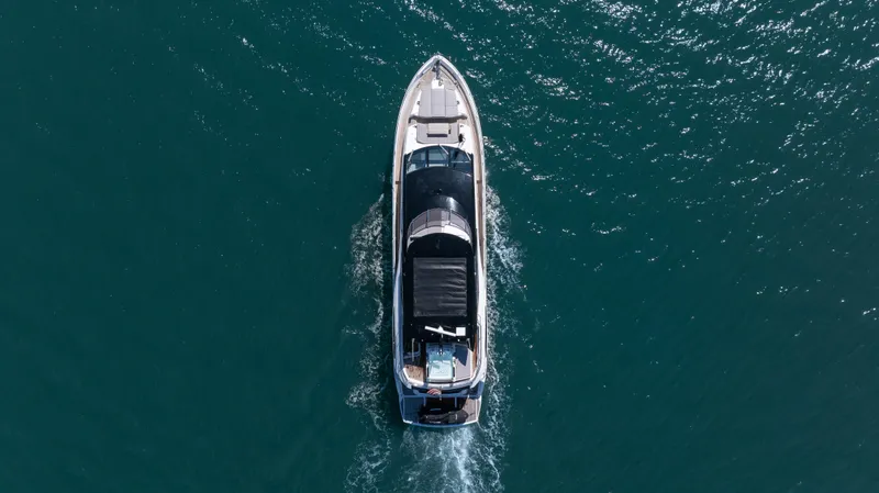 Hideout Yacht Photos Pics Aerial view of 2025 Sunseeker 88 Yacht cruising on open water.