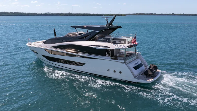 Hideout Yacht Photos Pics 2025 Sunseeker 88 Yacht cruising on open water, showcasing sleek design and luxury features.