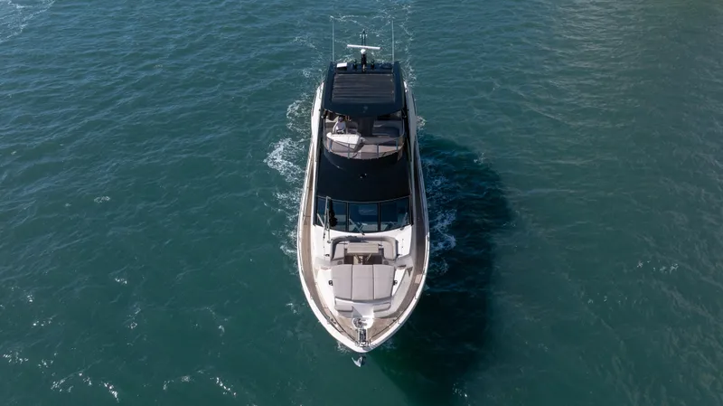 Hideout Yacht Photos Pics 2025 Sunseeker 88 Yacht cruising on open water, aerial view.