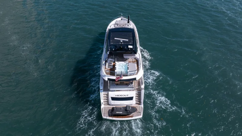 Hideout Yacht Photos Pics 2025 Sunseeker 88 Yacht cruising on open water, aerial view.