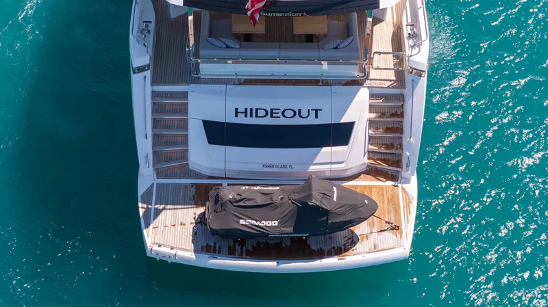 Hideout Yacht Photos Pics Aerial view of 2025 Sunseeker 88 Yacht "Hideout" on turquoise water.