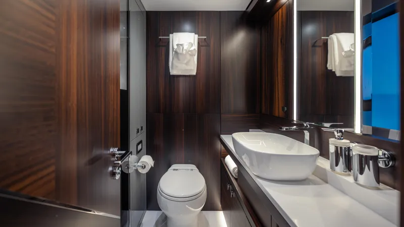 Hideout Yacht Photos Pics Luxurious bathroom in 2025 Sunseeker 88 Yacht with modern fixtures and elegant wood paneling.