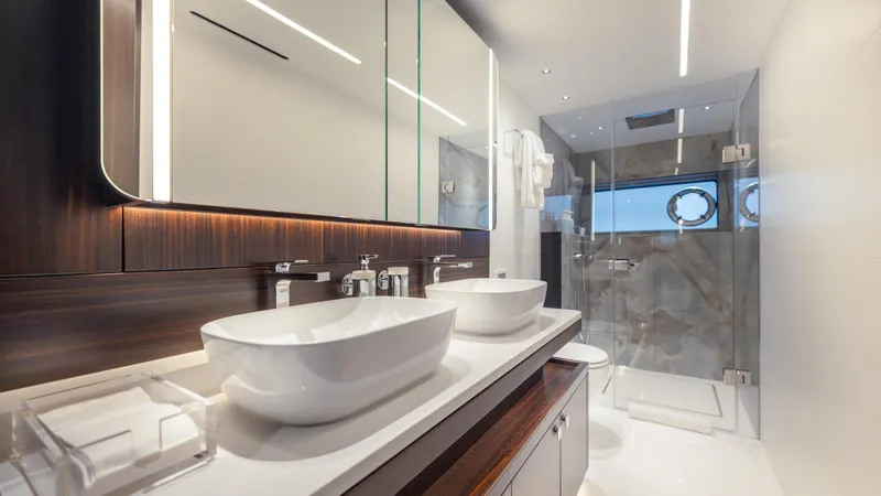 Hideout Yacht Photos Pics Luxurious bathroom in 2025 Sunseeker 88 Yacht with dual sinks and glass shower.