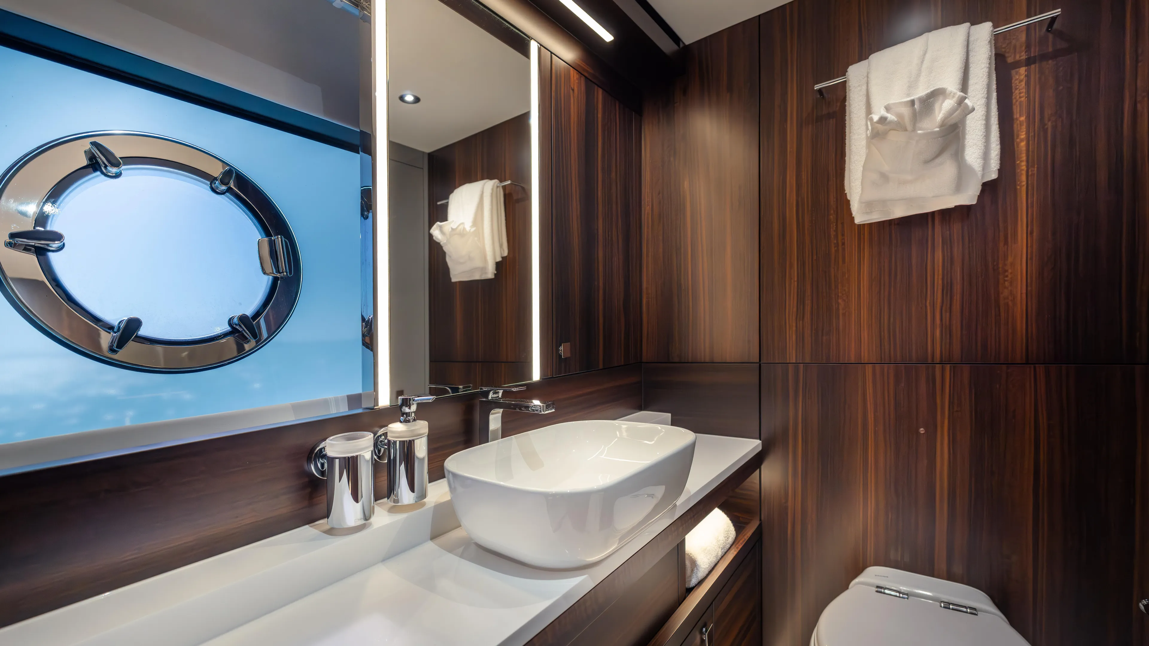 Hideout Yacht Photos Pics Luxurious bathroom in 2025 Sunseeker 88 Yacht with modern fixtures and porthole window.