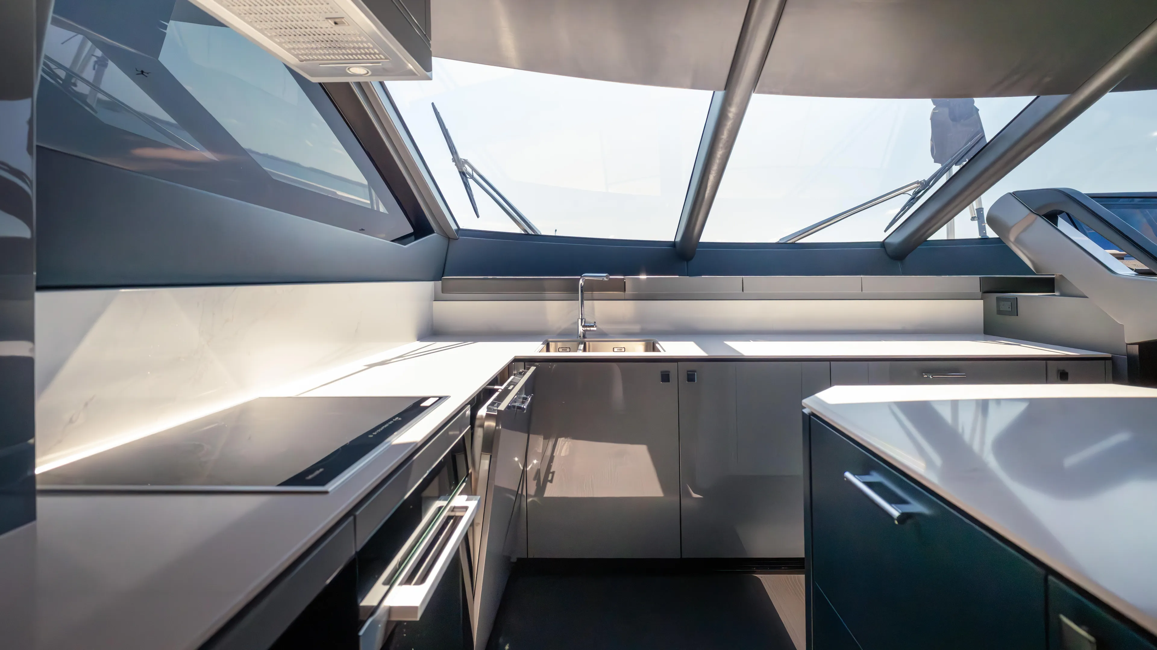 Hideout Yacht Photos Pics Modern kitchen interior of 2025 Sunseeker 88 Yacht with sleek design and large windows.