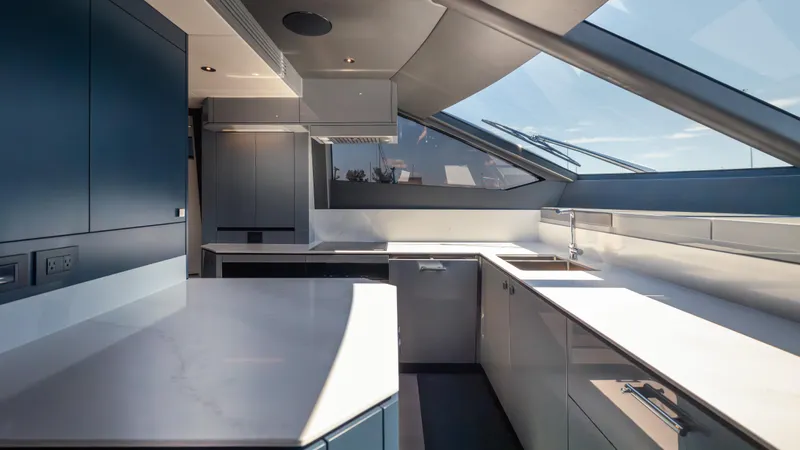 Hideout Yacht Photos Pics Modern kitchen interior of 2025 Sunseeker 88 Yacht with sleek design and ample natural light.