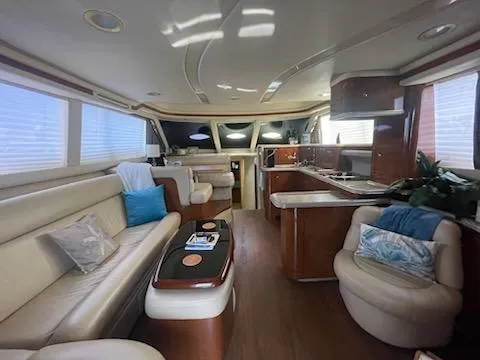  Yacht Photos Pics Luxurious interior of 2003 Sea Ray 480 Sedan Bridge yacht with elegant seating and modern kitchen.