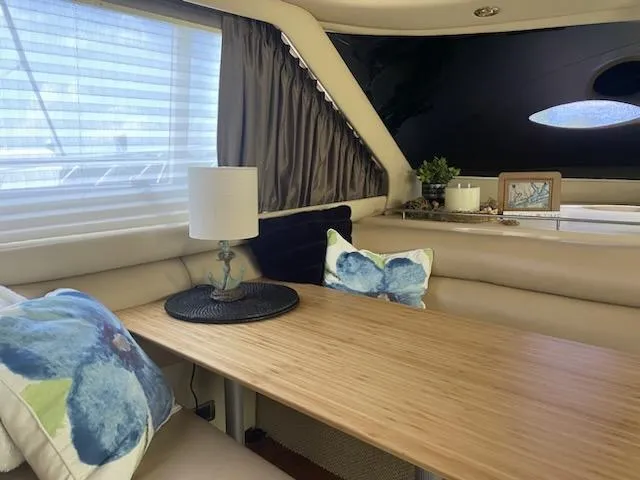  Yacht Photos Pics Interior of 2003 Sea Ray 480 Sedan Bridge with cozy seating and decorative pillows.