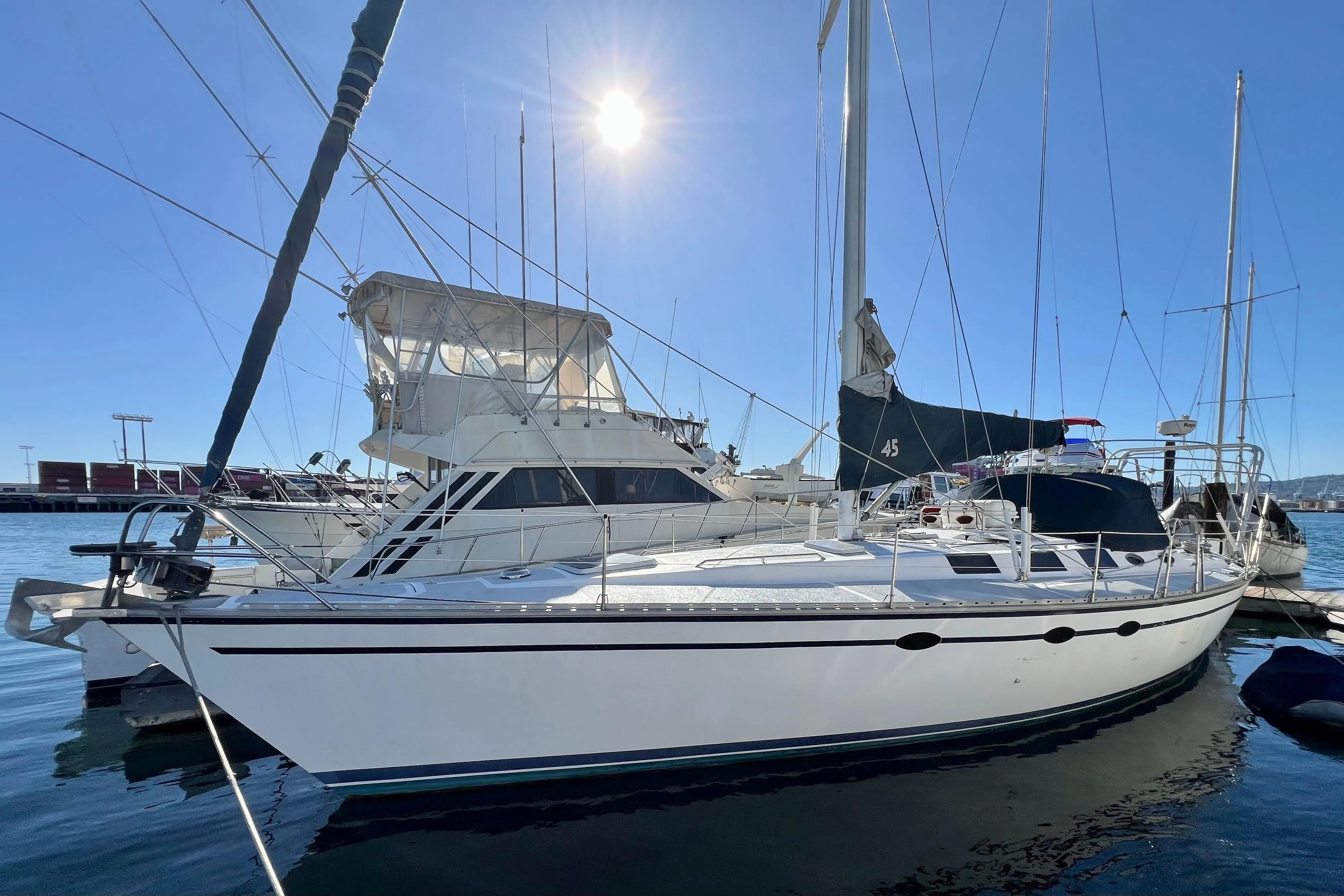 1986 Hunter Legend 45 sailboat docked in sunny marina.