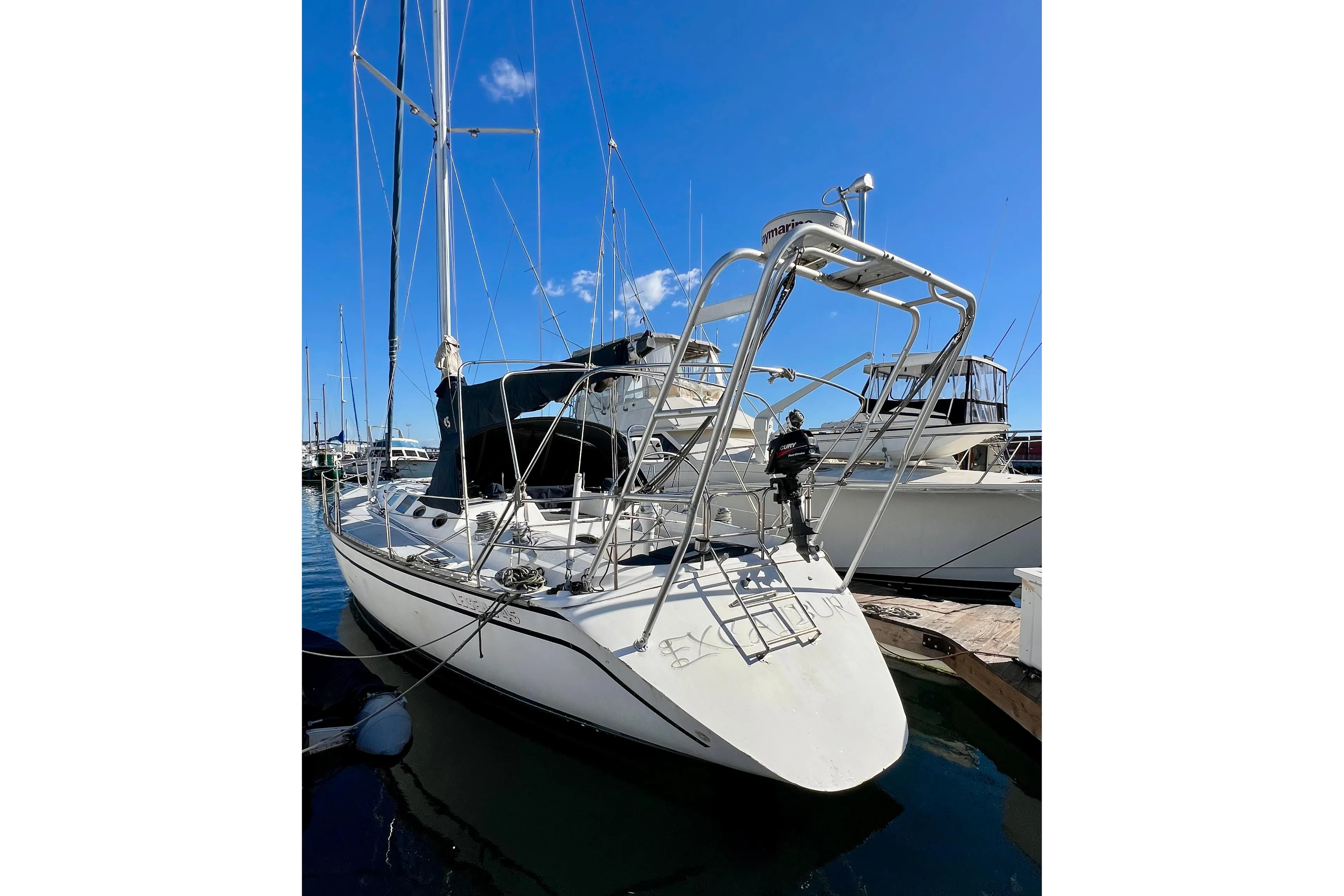 Sailboat docked in marina, 1986 Hunter Legend 45, clear blue sky.
