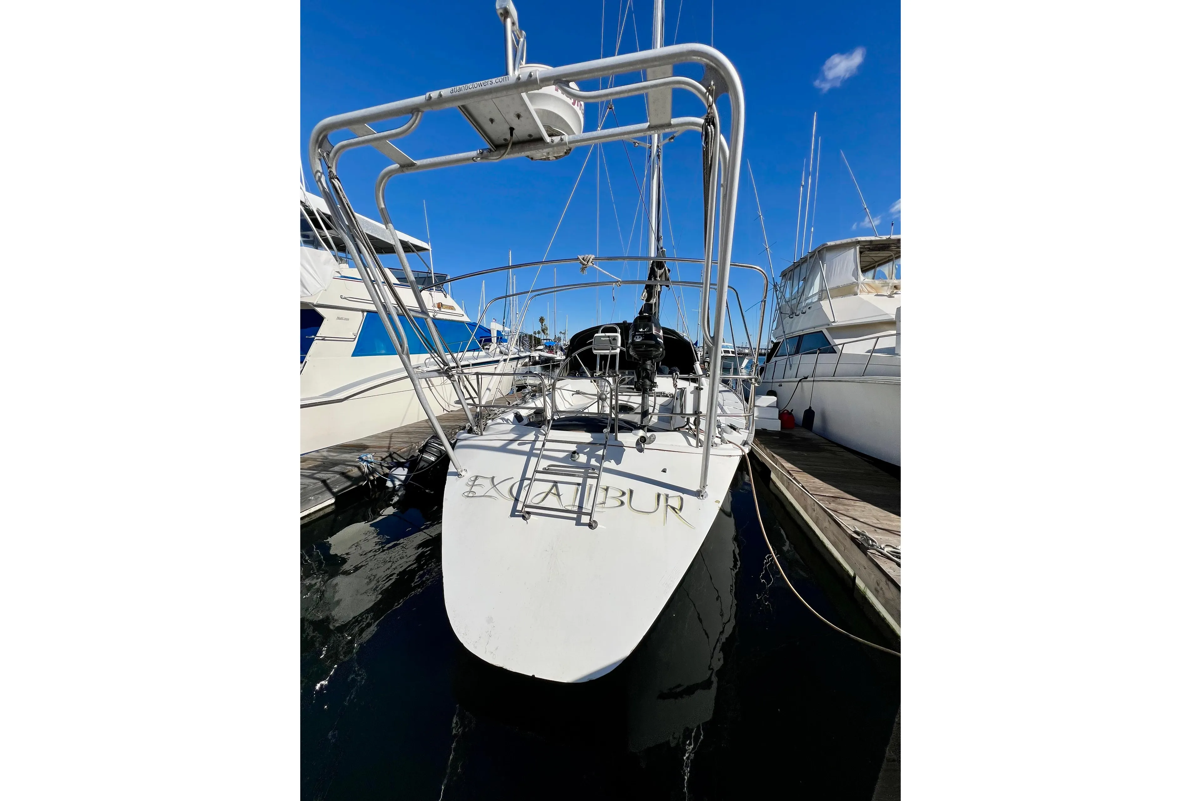 1986 Hunter Legend 45 sailboat docked at marina under clear blue sky.