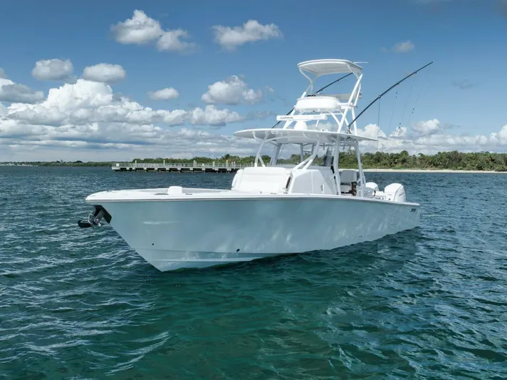  Yacht Photos Pics 2023 Jupiter 40 boat on clear blue water under a partly cloudy sky.