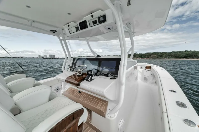  Yacht Photos Pics 2023 Jupiter 40 boat interior with helm, luxurious seating, and ocean view.