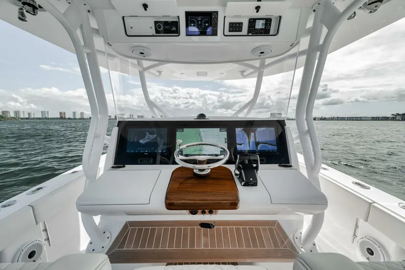  Yacht Photos Pics 2023 Jupiter 40 boat helm with modern controls, steering wheel, and ocean view.