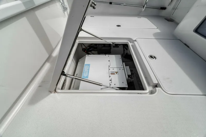  Yacht Photos Pics 2023 Jupiter 40 boat storage compartment with open hatch, showcasing interior equipment.
