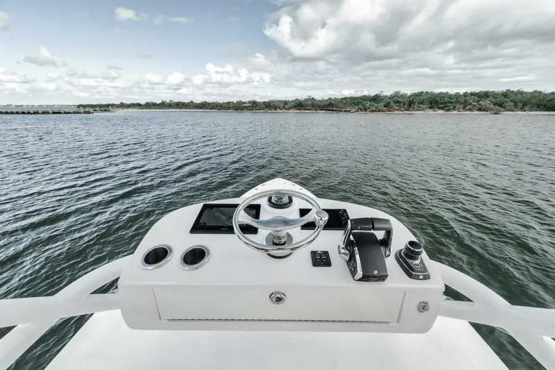  Yacht Photos Pics 2023 Jupiter 40 boat helm with steering wheel, controls, and ocean view.